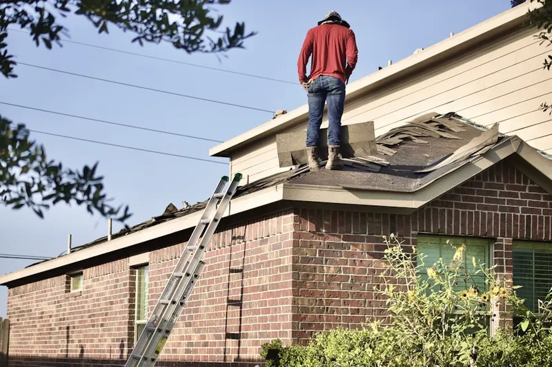 Professional roofer working on a residential roof in Quimby